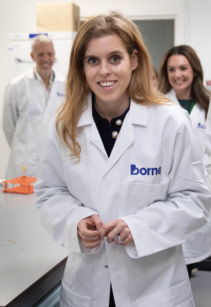 Princess Beatrice smiling in lab coat