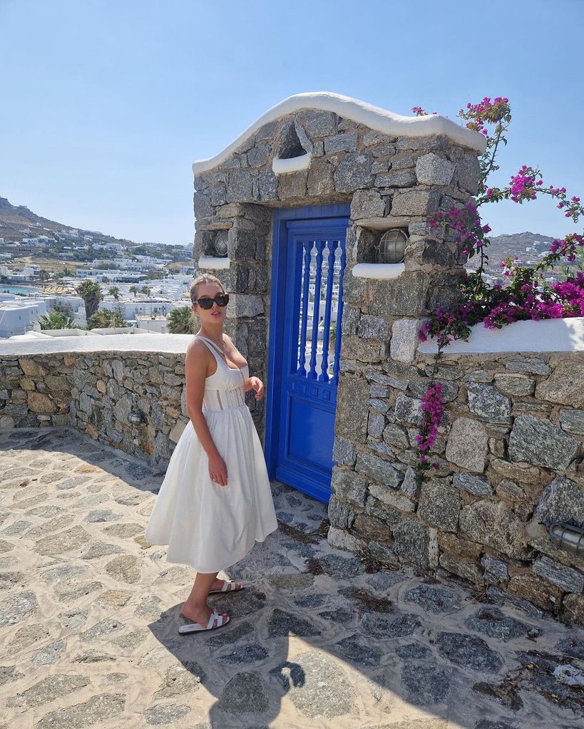 Helen Flanagan posing in front of a blue door in Greece