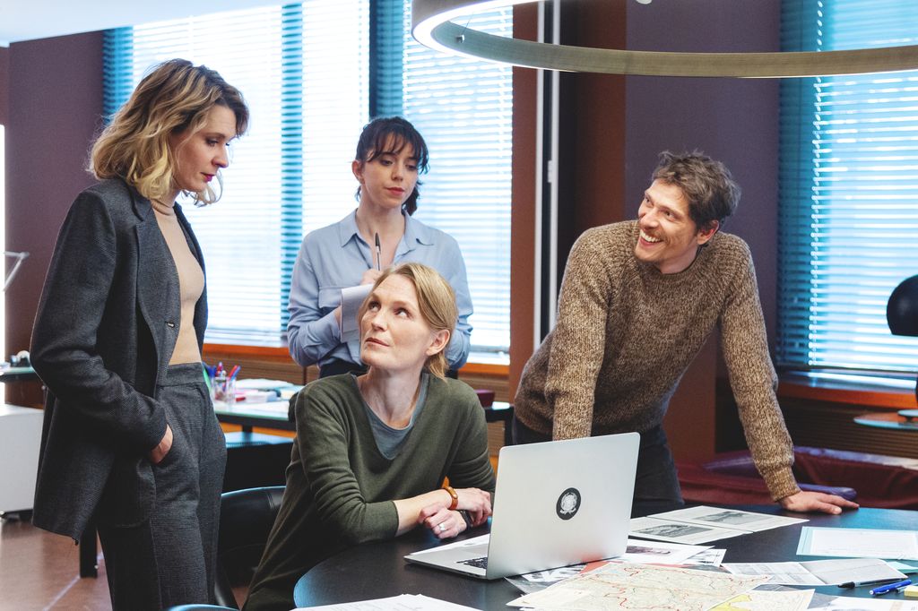 group of people gathered around computer