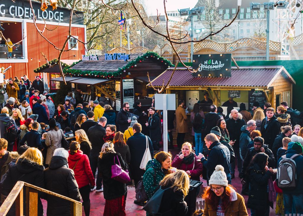 people walking through christmas market on london southbank