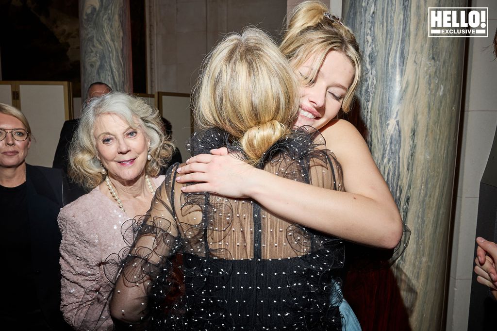 Apple Martin hugging Gwyneth Paltrow as Blythe Danner looks on