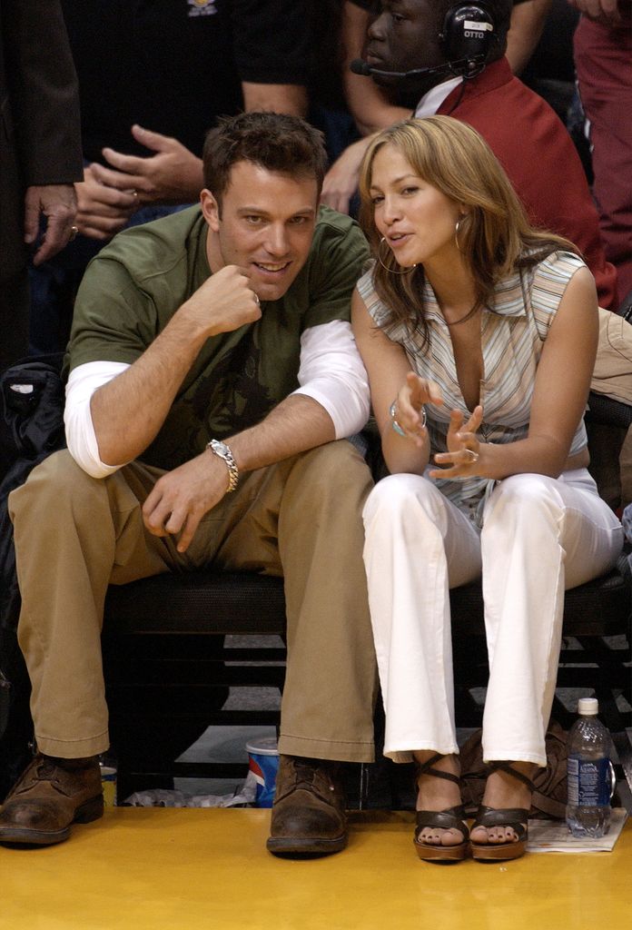 Ben Affleck (L) and his fiance actress/singer Jennifer Lopez attend the Los Angeles Lakers v. San Antonio Spurs playoff game at the Staples Center May 11, 2003 in Los Angeles, California.  Lopez and Affleck postponed their wedding, which was scheduled for this weekend, and has now reportedly spit up, possibly temporarily.   (Photo by Vince Bucci/Getty Images)