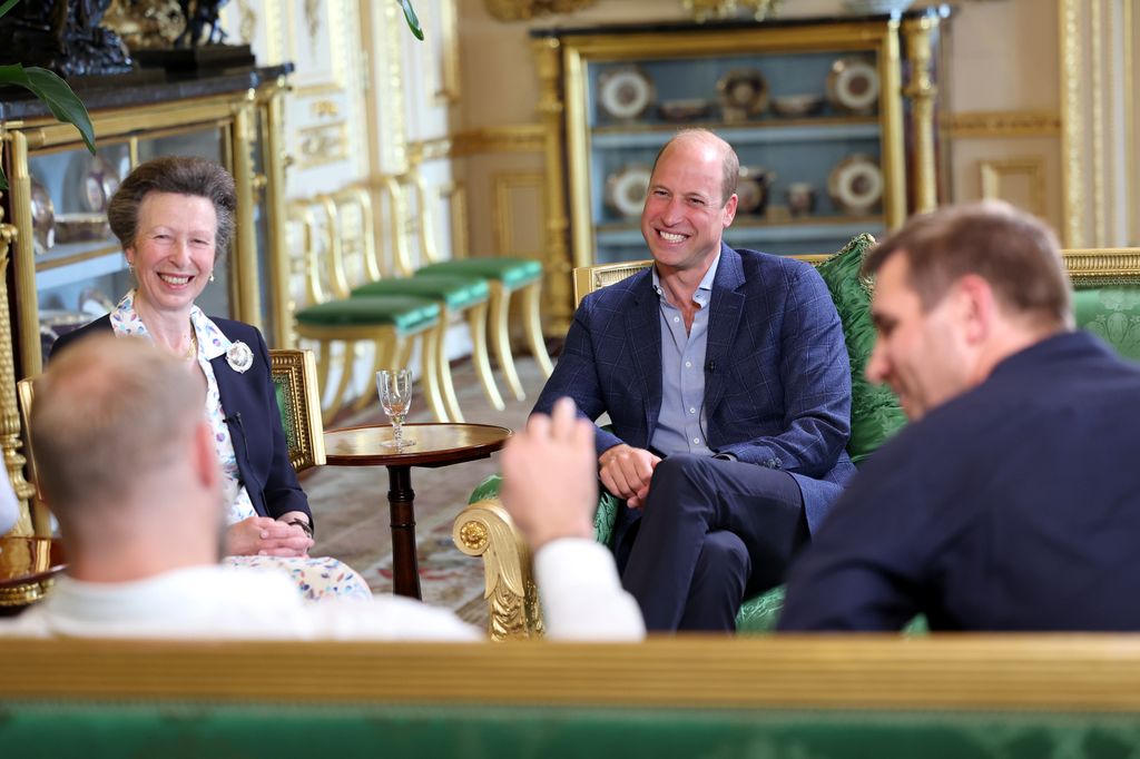 royals laughing on green sofas 