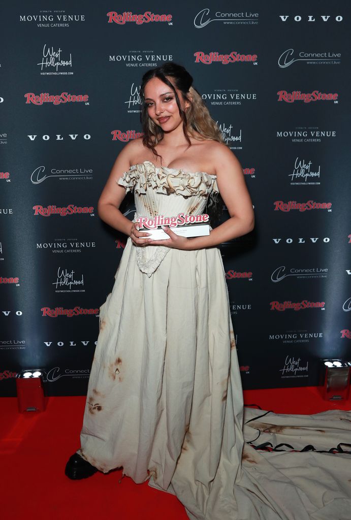 Jade Thirlwall poses with award in grungy gown