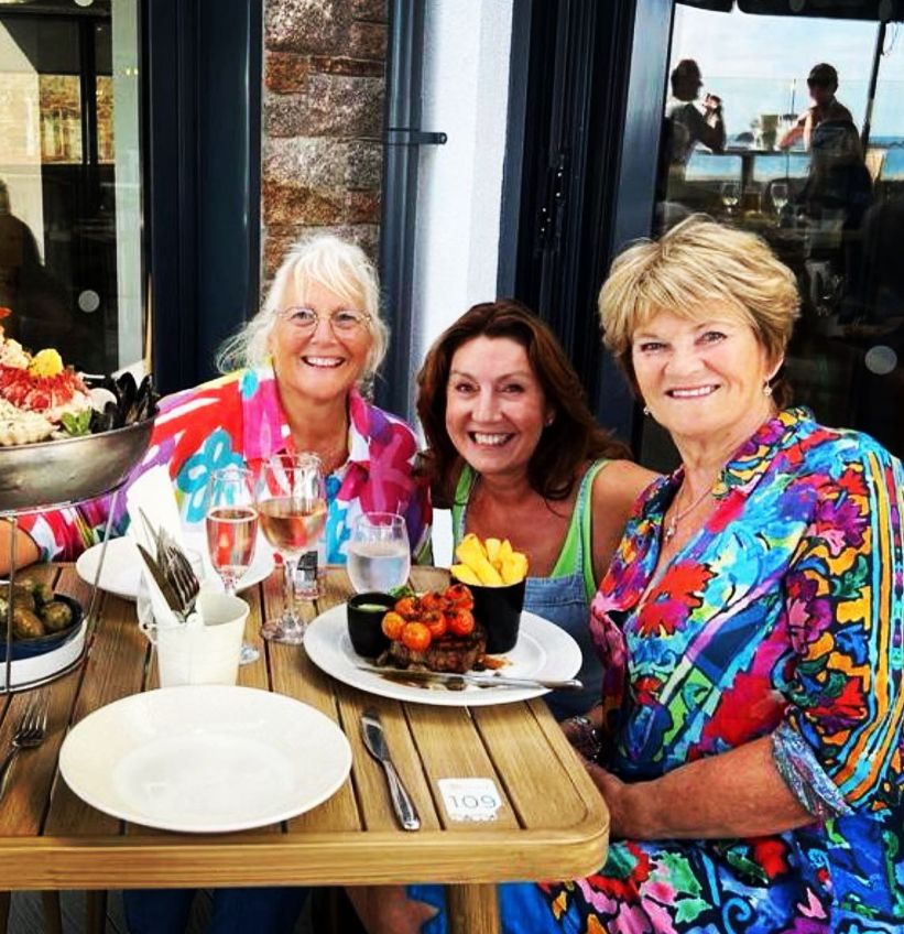 Jane McDonald sat with two women at an outdoor cafe