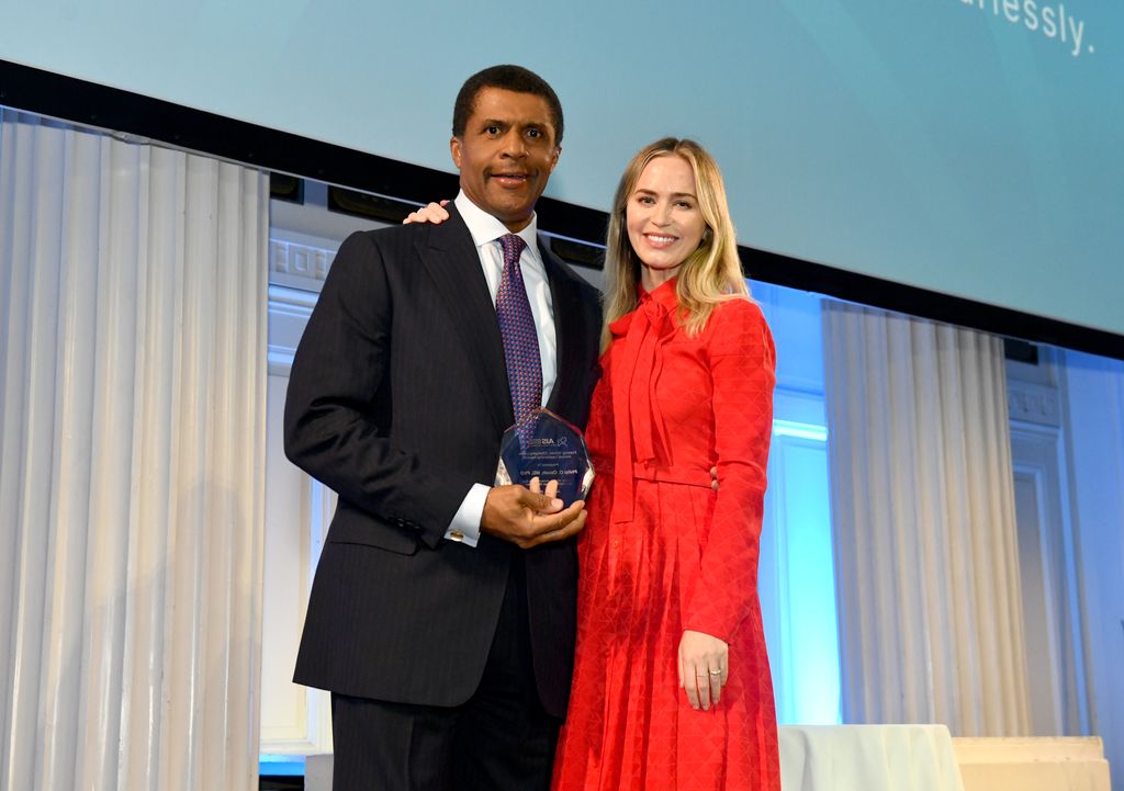 Emily Blunt presents an award to Dr. Philip O. Ozuah (L) onstage during the American Institute For Stuttering 17th Annual Gala hosted by Emily Blunt on June 12, 2023 in New York City