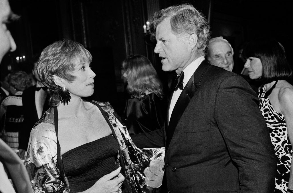 Shirley Maclaine speaking with Senator Edward M Kennedy at a black tie event in 1984