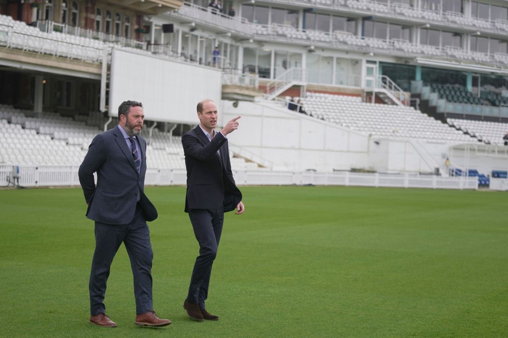 Prince William on pitch with Oliver Slipper, Chair of Surrey County Cricket Club 