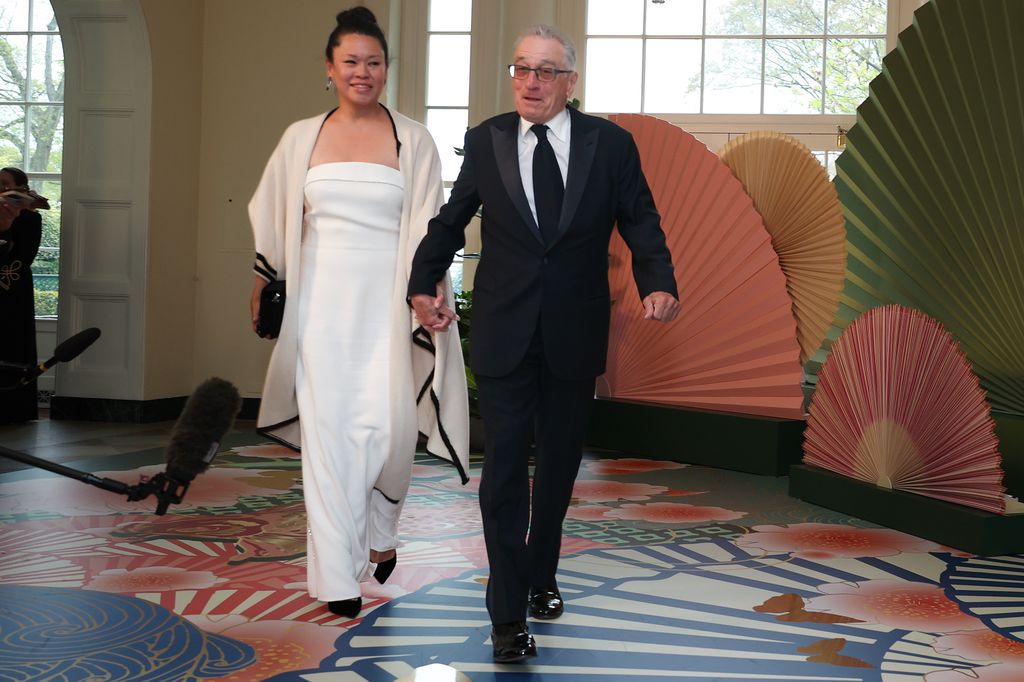 Robert De Niro (R) and Tiffany Chen arrive at the White House for a state dinner 