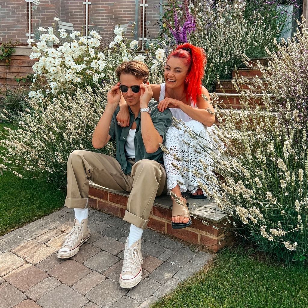 The couple were pictured seated in a colourful garden