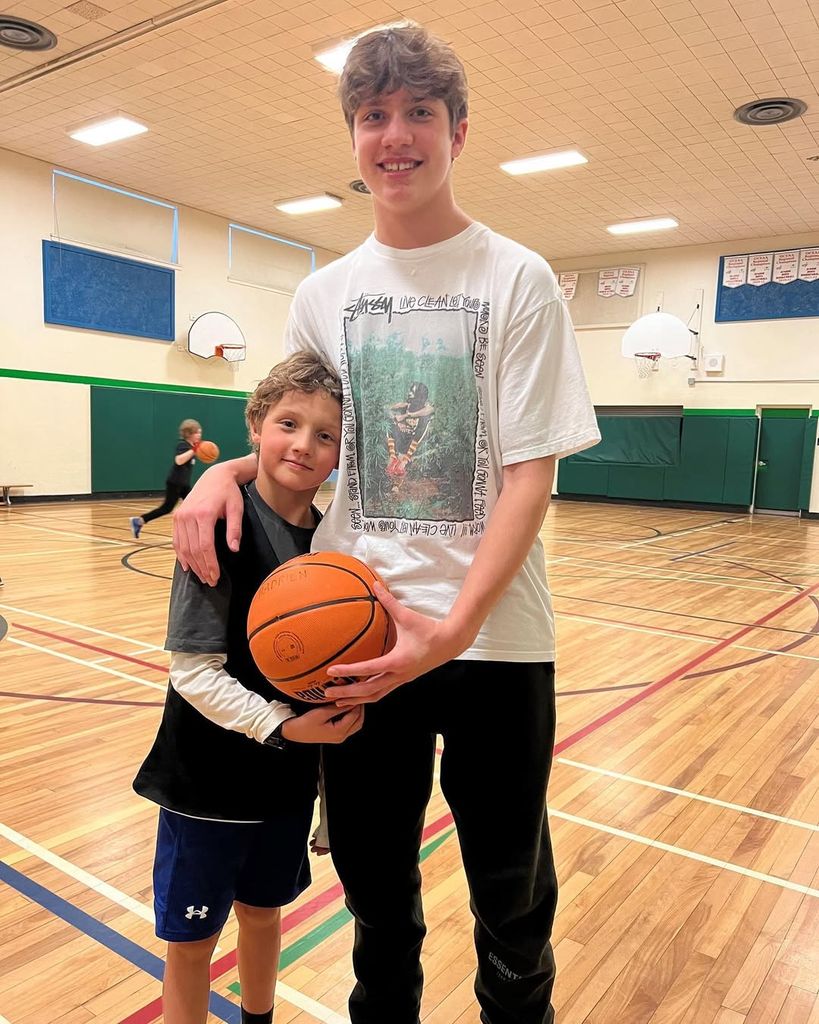 Hadrien is learning how to play basketball from his big brother