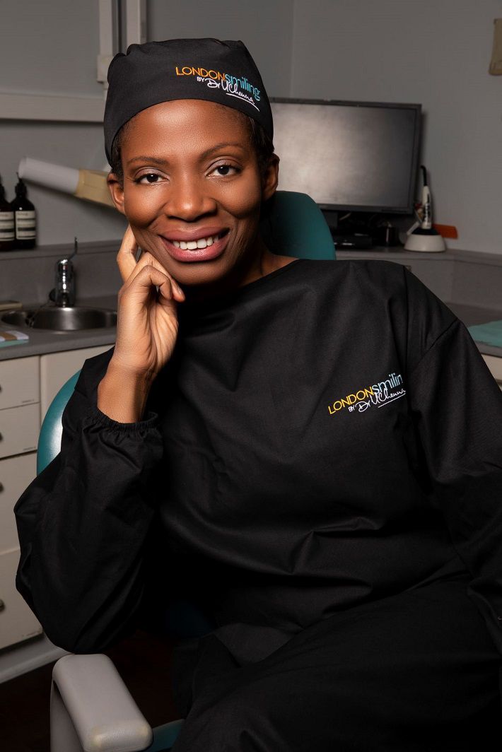 Dr. Uchenna smiling in her dentistry outfit