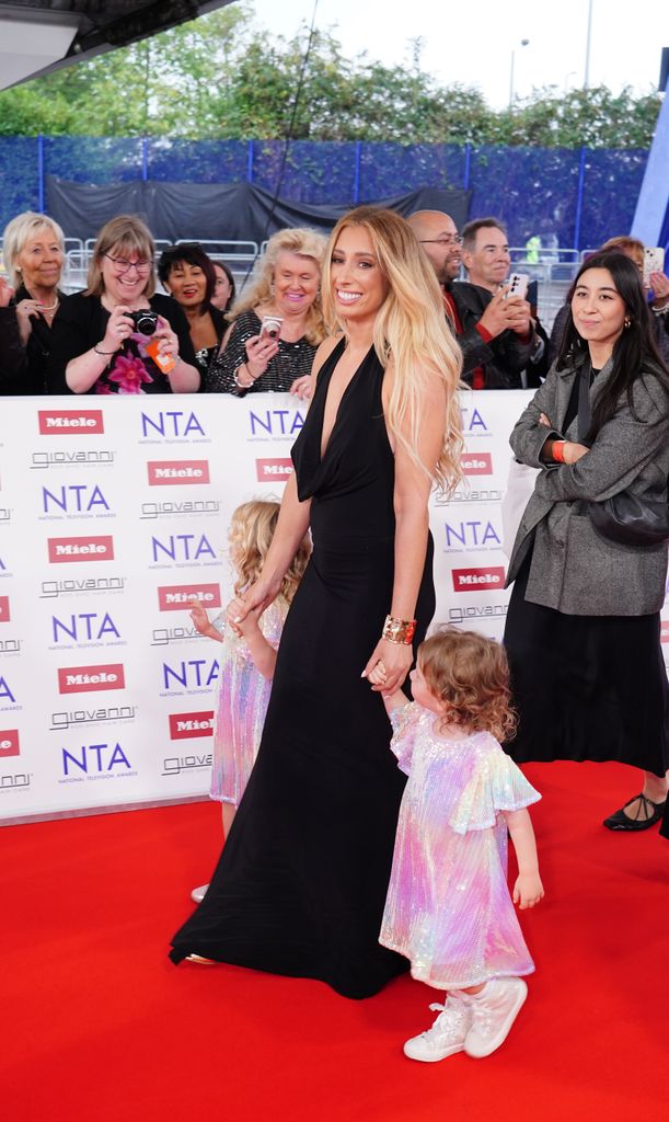 Stacey Solomon in a black dress with her daughters on the red carpet