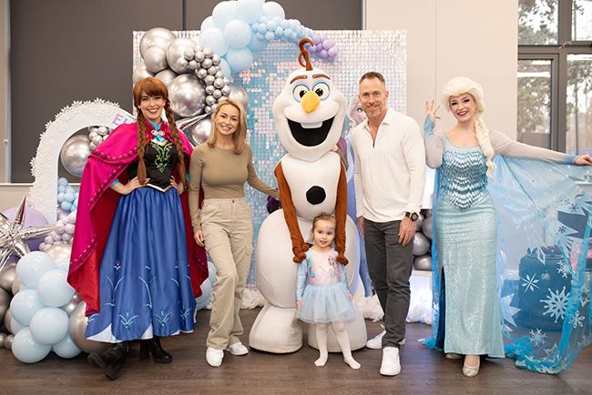 Ella with characters from Frozen at her party