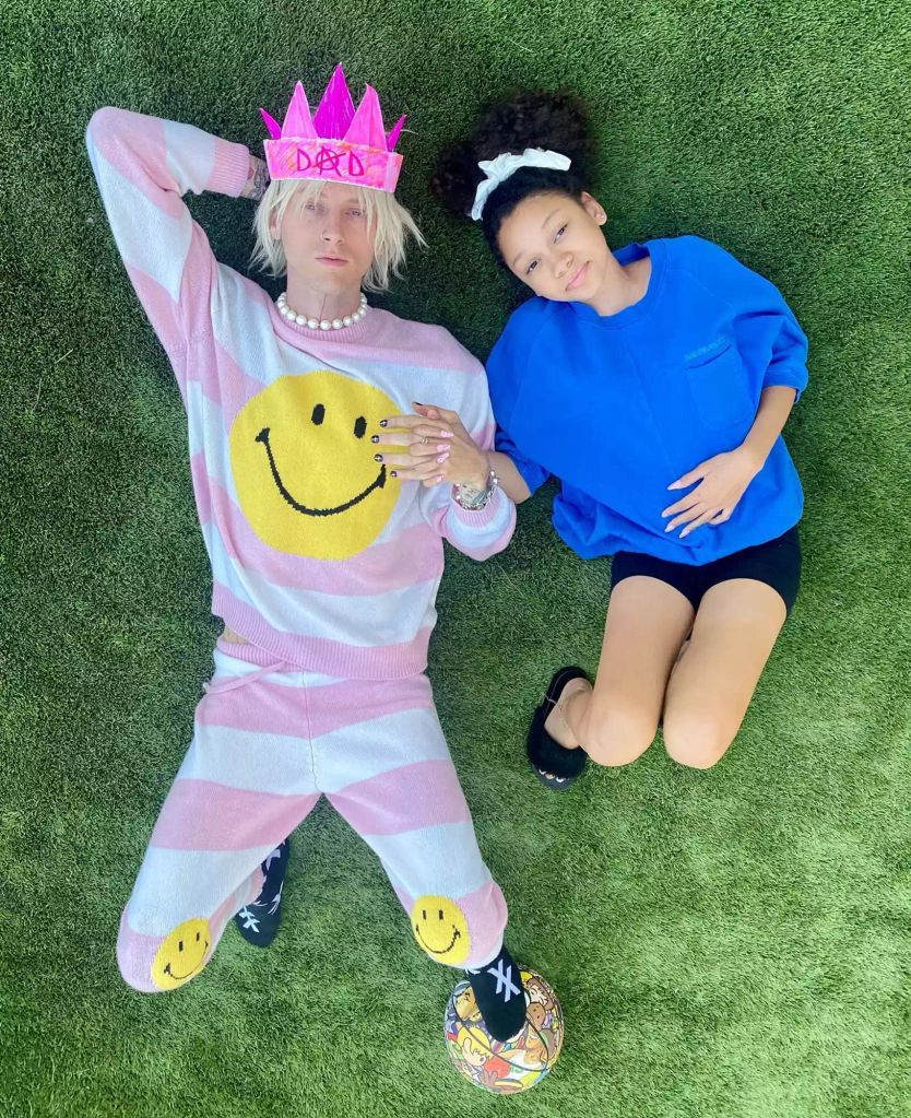 MGK lies in the grass with daughter