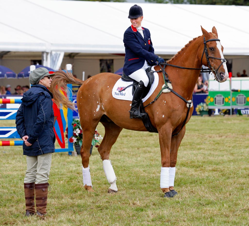 Princess Anne looks on as Zara Phillips rides her horse 'Toytown' 