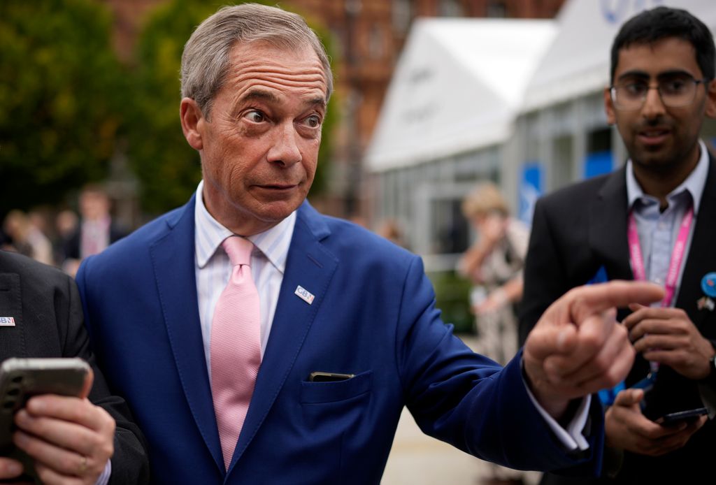 Nigel Farage walking in a blue suit
