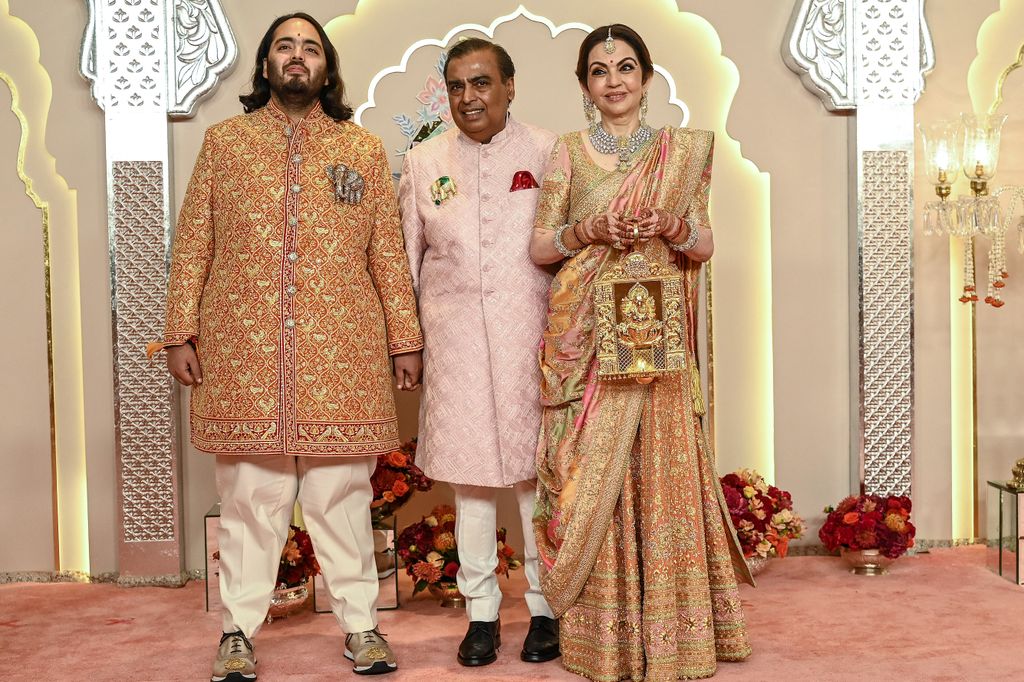 Nita and Mukesh Ambani with their son Anant posed for photos as they arrived to attend the wedding ceremony 