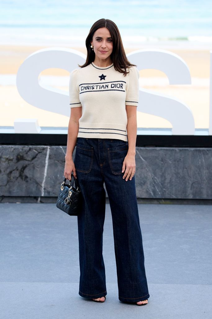 Macarena García wears cropped Dior knit sweater and classic wide-leg dark denim. This effortless outfit blended high fashion with laid-back vibes, perfect for a seaside event. 