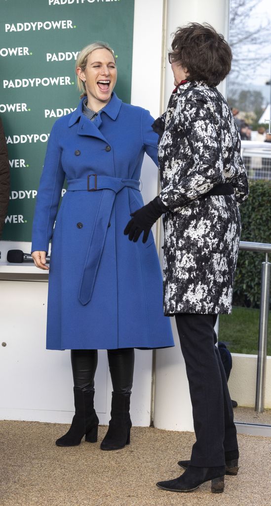 Zara in blue coat laughing with lady