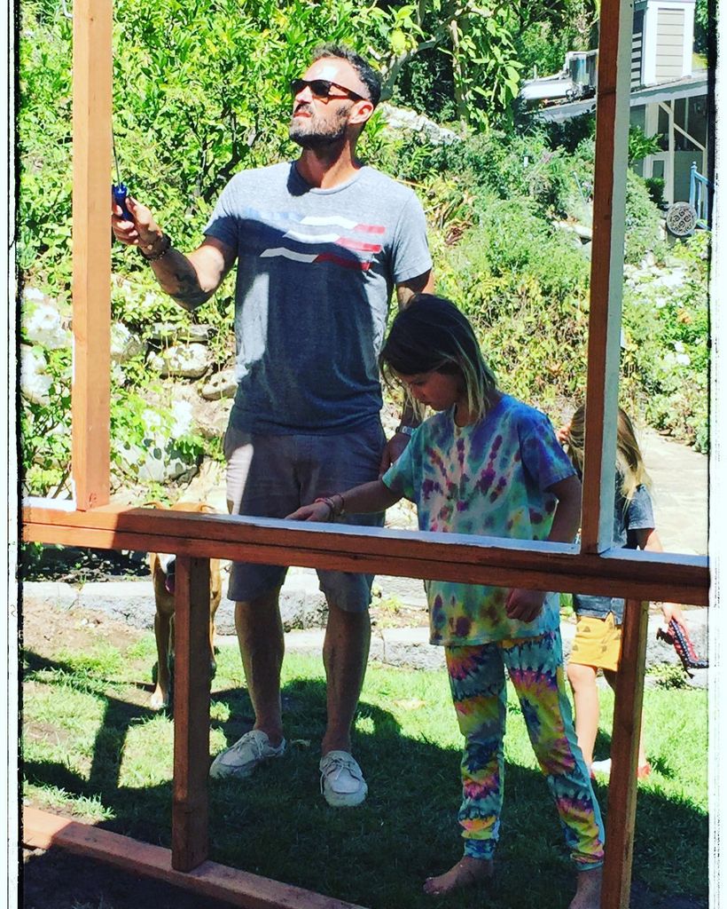 brian with son painting wood frame
