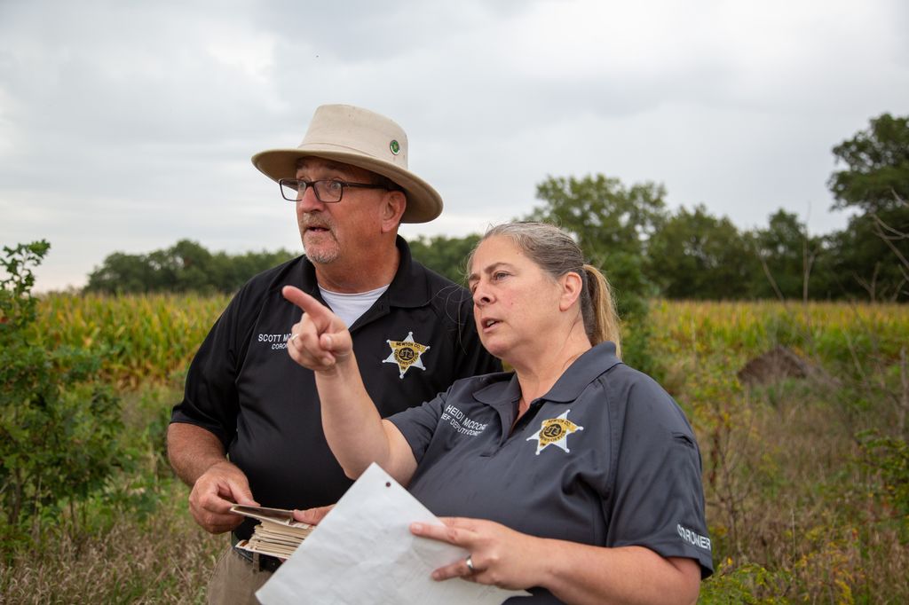 two police officers standing in field