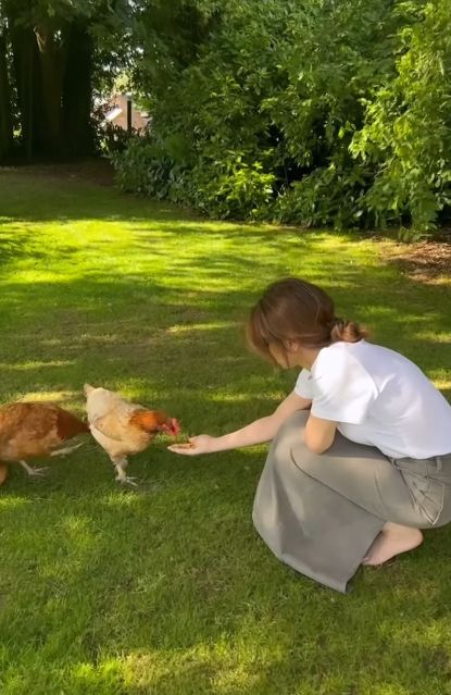 Cheryl feeding chickens on holiday in Cumbria