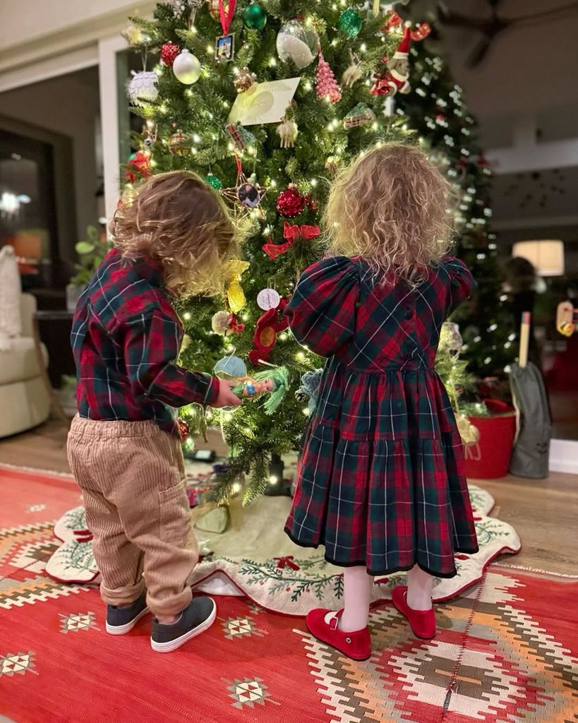 Hilary Swank's twins Aya and Ohm fiddle with the family's Christmas tree inside their home, shared on Instagram