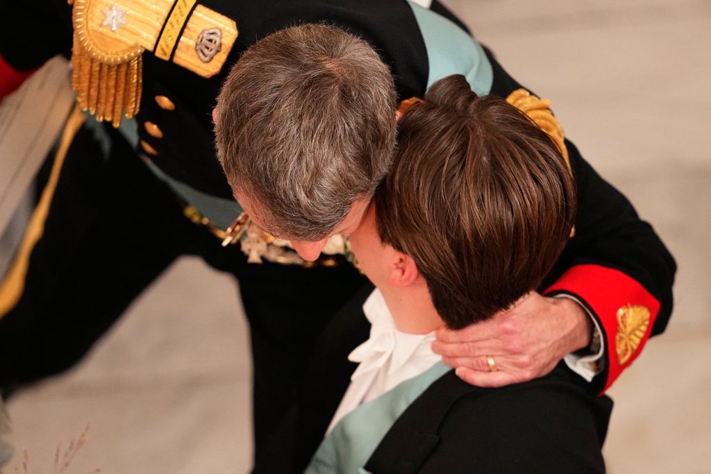 Denmark's Crown Prince Frederik and Denmark's Prince Christian exchange a kiss 