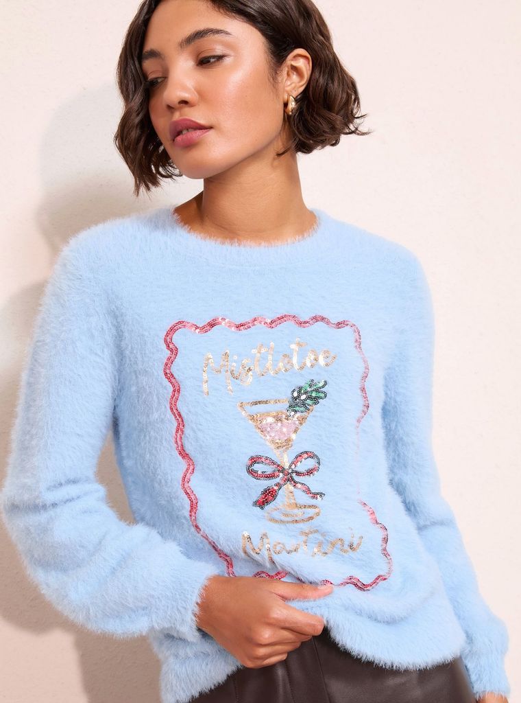 Next blue Christmas jumper on woman with cocktail on the front