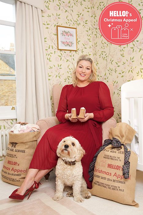 Natalie Rushdie at home with her dog posing with her donations for Little Village