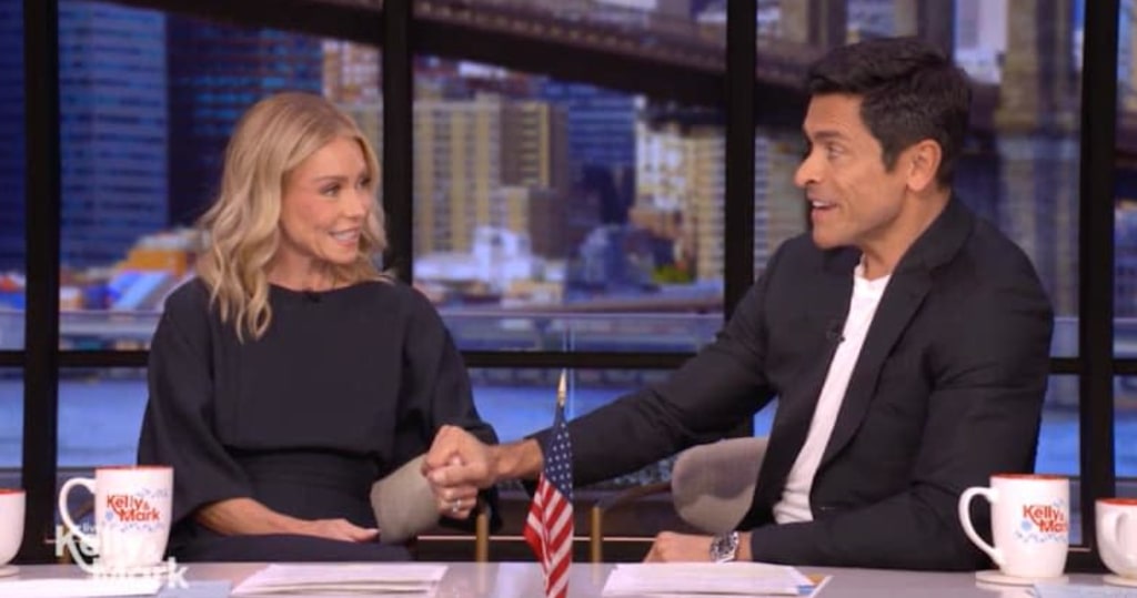 Kelly Ripa in navy dress and Mark Consuelos in blazer on LIVE
