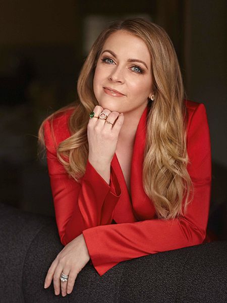 Melissa Joan Hart looks thoughtful as she poses in red silk top