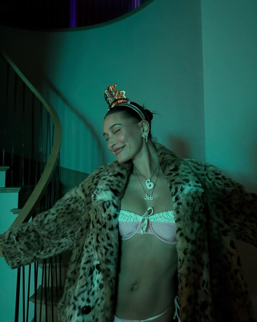 Hailey Bieber in a bikini and fur coat