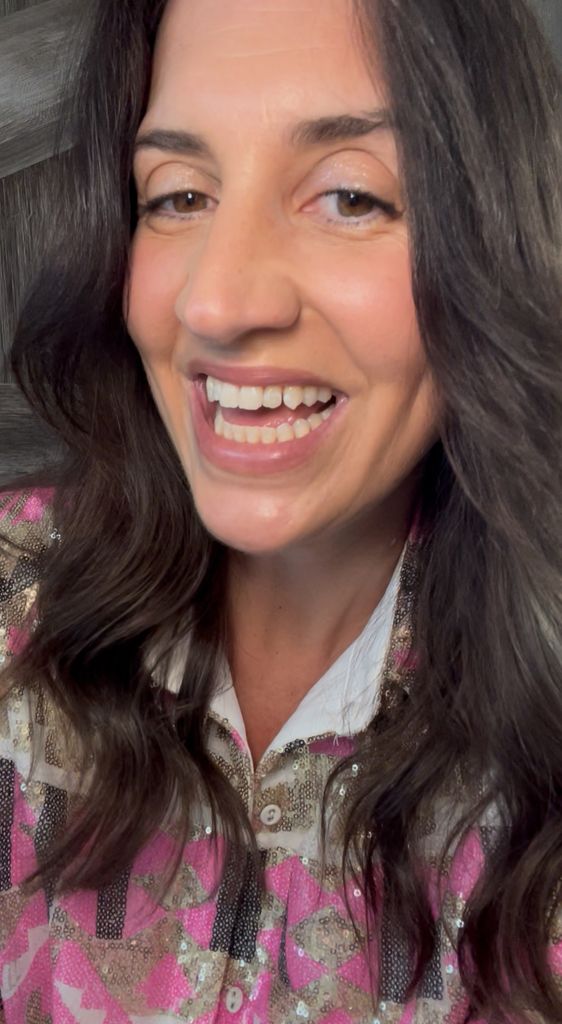 Donna's curtain bangs are cut long and parted in the middle