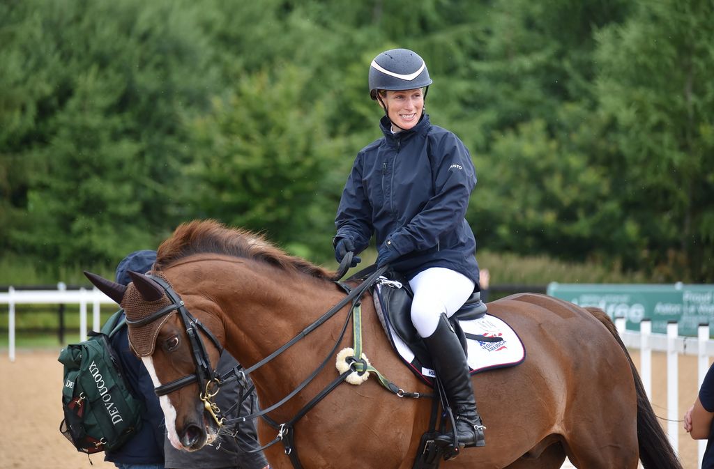 woman riding horse at competition