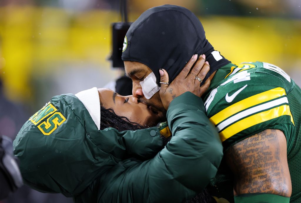 Olympic gold medalist Simone kisses her husband before a Green Bay Packers game in December 2023