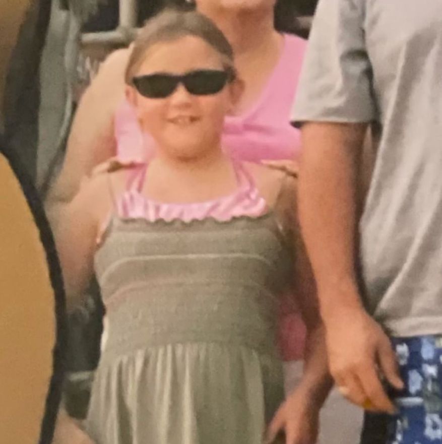 Young Gracie McGraw in sunglasses and dress