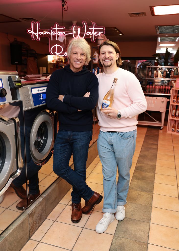 Jon Bon Jovi in black sweater and Jesse Bongiovi in pink jumper attend Hampton Water celebrates Bubbly with Jon Bon Jovi at La La Laundry 