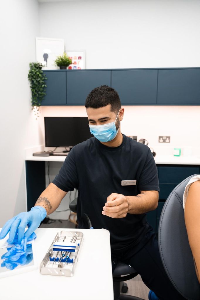 dentist with blue gloves and a mask