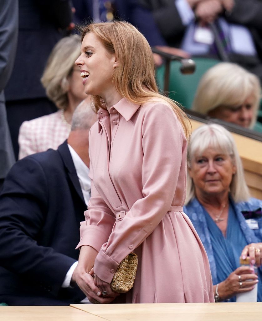 Princess Beatrice laughing at Wimbledon semi finals wearing pink shirt dress