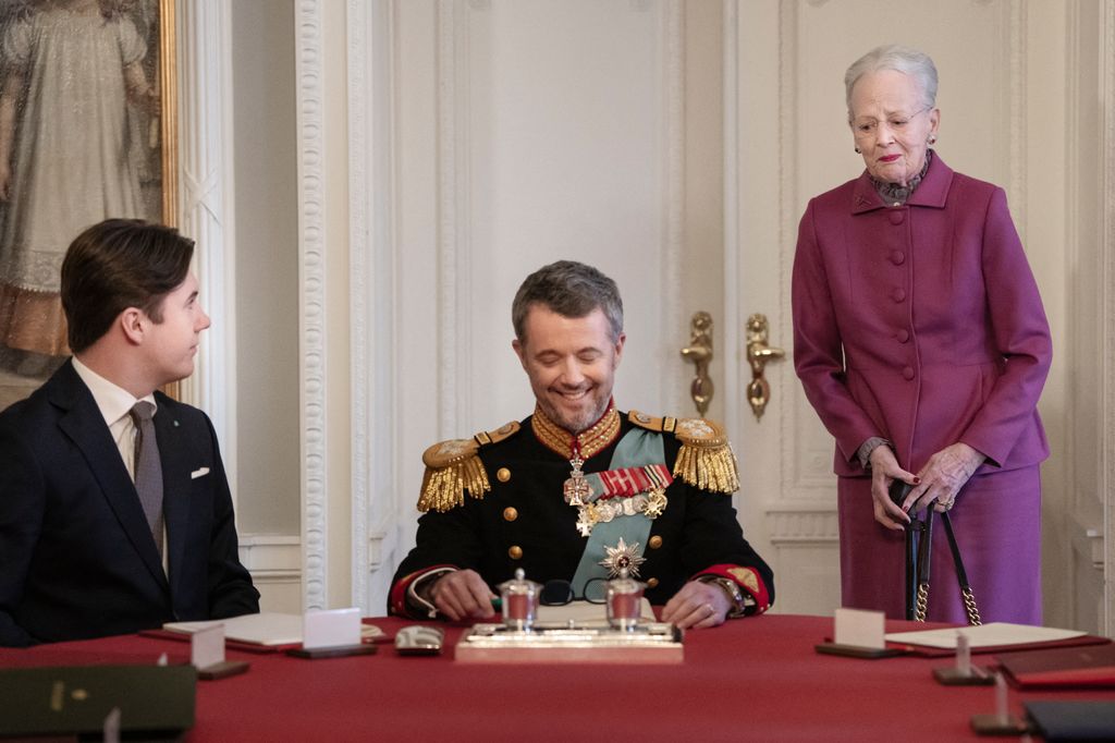Queen Margrethe II standing behind her son King Frederik X of Denmark 