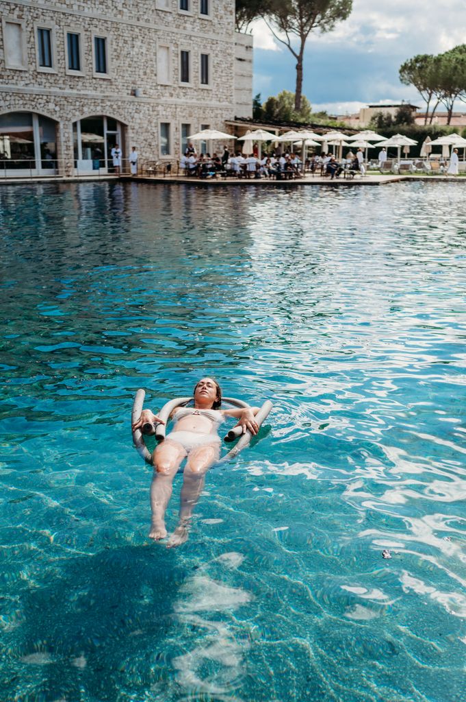 A woman relaxing in a hot spring in Tuscany, Italy