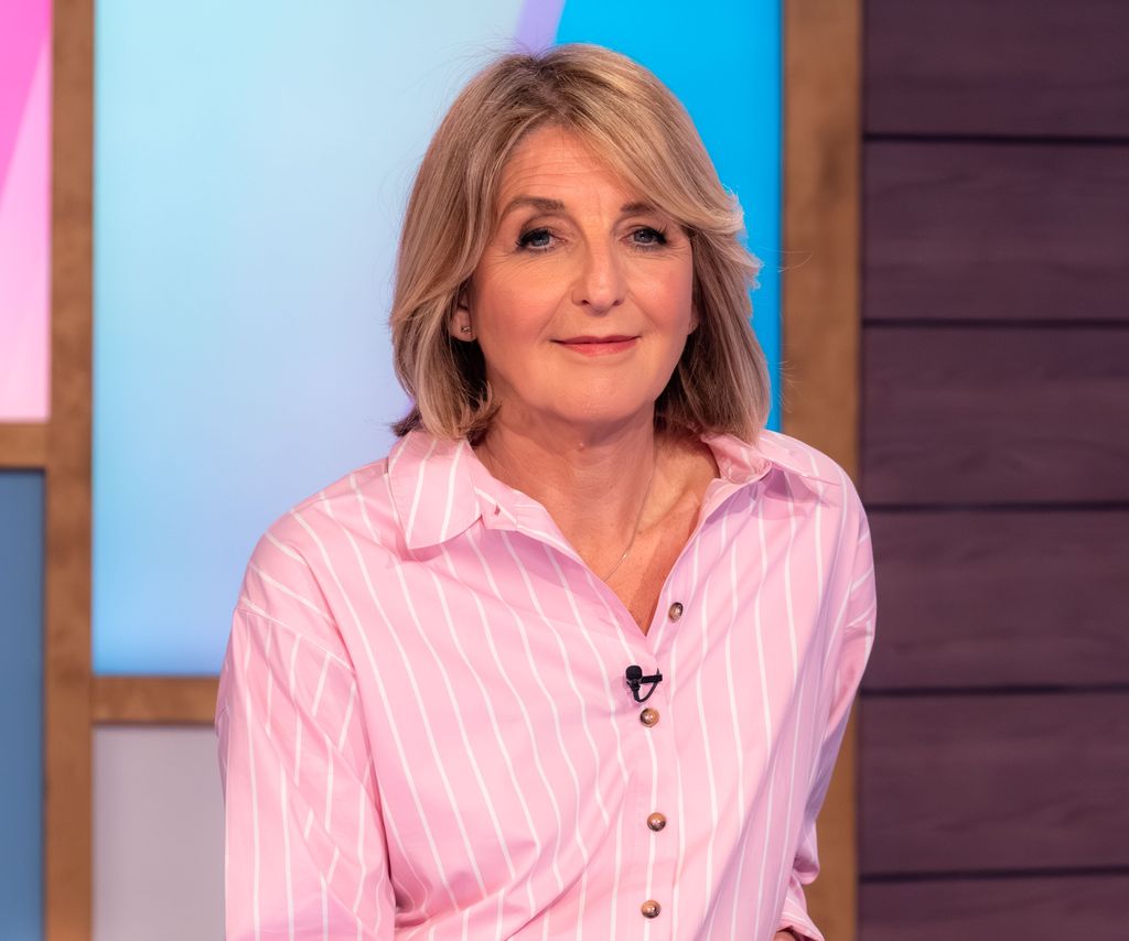Kaye Adams on loose women looking serious in pink striped shirt