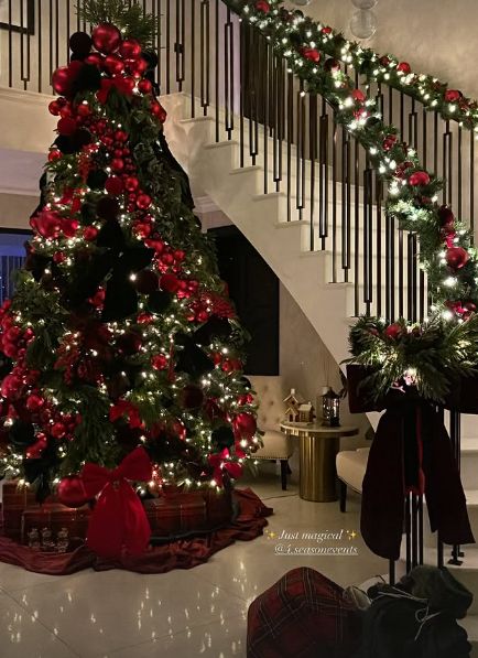A large Christmas tree in the foyer of a home