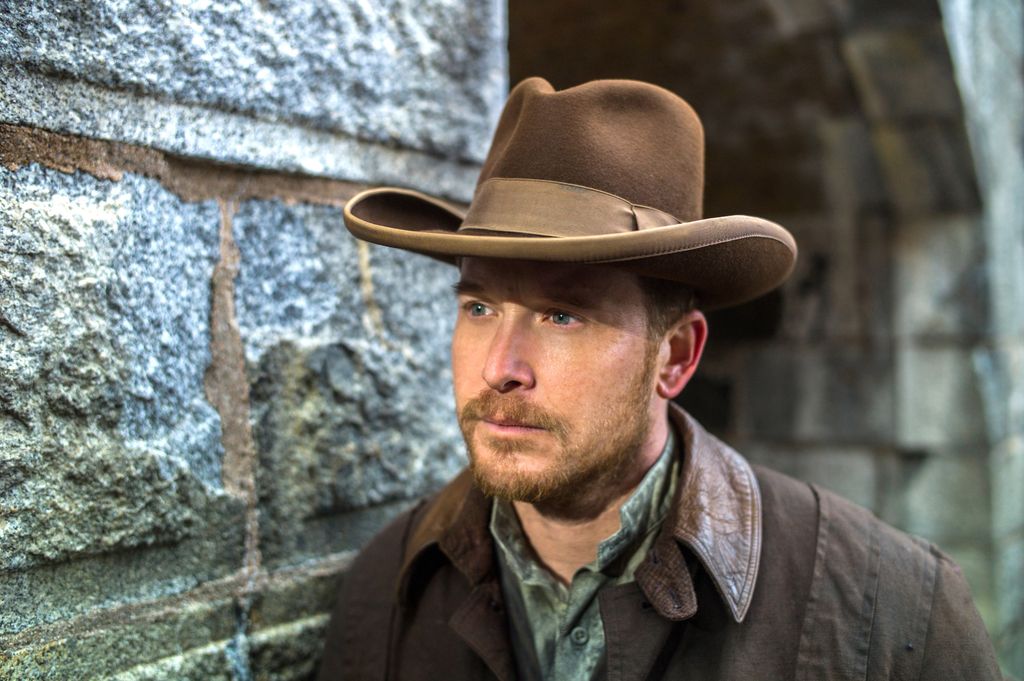 close-up of man wearing cowboy hat