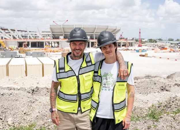 David Beckham with his arm around Cruz Beckham on a construction site