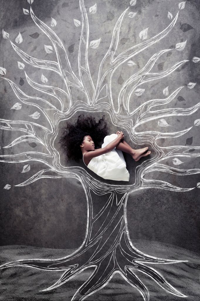 Little Black girl rests in the branches of a chalkboard-sketched tree