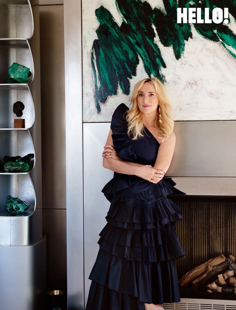 Inge relaxes in a ruffled one-shoulder top and asymmetrical layered midiskirt in the three-storey apartment in Antwerp’s Graanmarkt Square