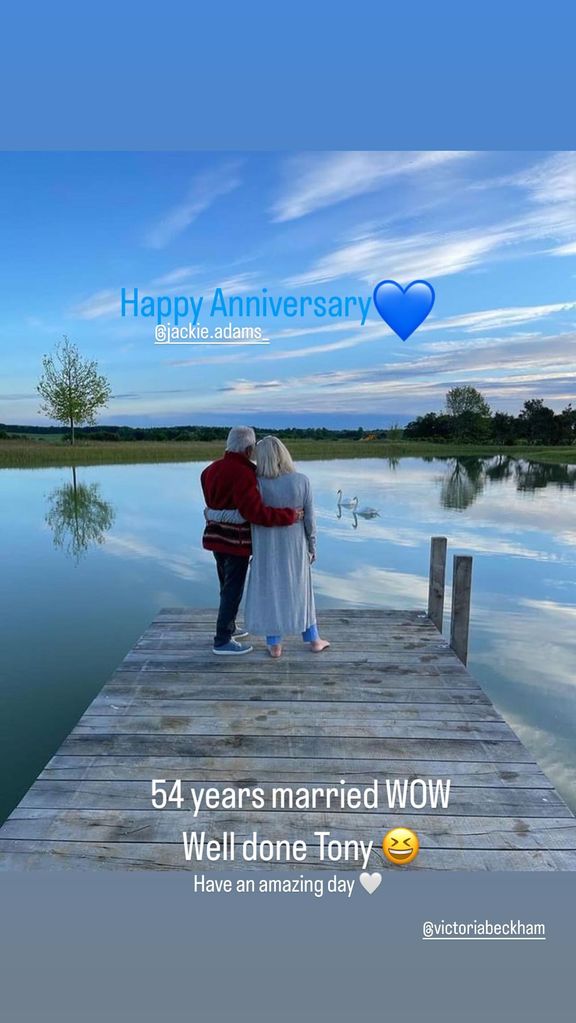 picture of couple standing on jetty overlooking lake